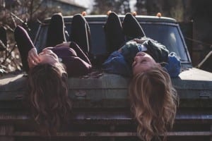 teen-girls-laughing-on-car-road-trip